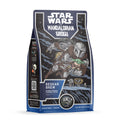 The front of a twelve ounce bag of flavored coffee named Beskar Brew. It is blondie brownie flavored, and on the art is the Mandolorian holding Grogu.