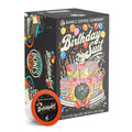 The front of the Bones Coffee Company Birthday Suit 12 Count Bones Cups box. Its flavor is birthday cake, and it has a skeleton laying on a birthday cake with a birthday hat blowing into a streamer on the art.
