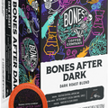 A boxed coffee product labeled Bones After Dark Dark Roast Blend by Bones Coffee Company, shown with a single orange coffee cup lid in front on a plain white background.