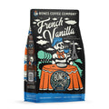 The front of a 12 ounce bag of Bones Coffee Company French Vanilla coffee. Its flavor is a creamy vanilla, and it has a skeleton wearing a beret with a black and white striped shirt drinking coffee before the Eiffel tower on the art.