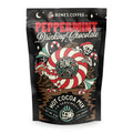 A bag of drinking chocolate mix that has peppermint in it. The art has a skeleton and reindeer wearing a santa clause cap hiding behind a giant peppermint circle.